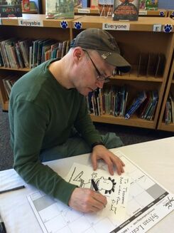 Lincoln Pierce signs books for students